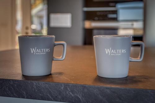 two coffee mugs sitting on top of a counter at Walters Waldport in Waldport