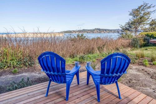 two blue chairs sitting on top of a deck at Walters Waldport in Waldport