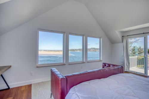 a bedroom with a bed and three windows at Walters Waldport in Waldport