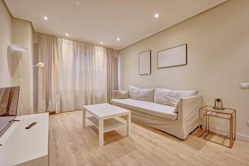 a living room with a couch and a table at La paz home by Clabao in Logroño
