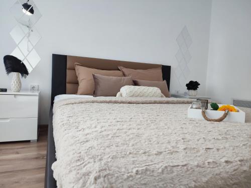 a bedroom with a large bed and a white wall at Summer day Chernomorets in Chernomorets