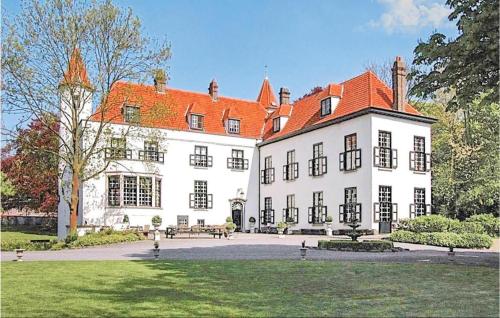 a large white building with a red roof at Kasteel Ter Leyen in Assenede
