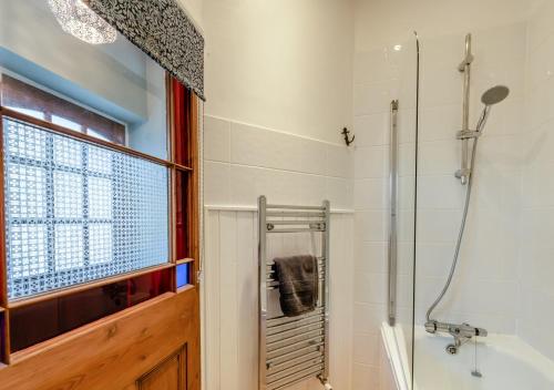 a bathroom with a shower and a bath tub at Ship Ahoy in Appledore