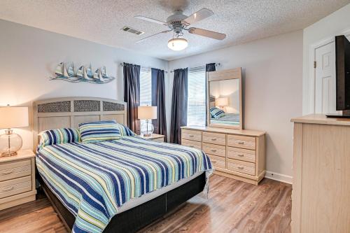 a bedroom with a bed and two dressers and a window at Murrells Inlet Condo with Pool Access, Near Beach! in Myrtle Beach