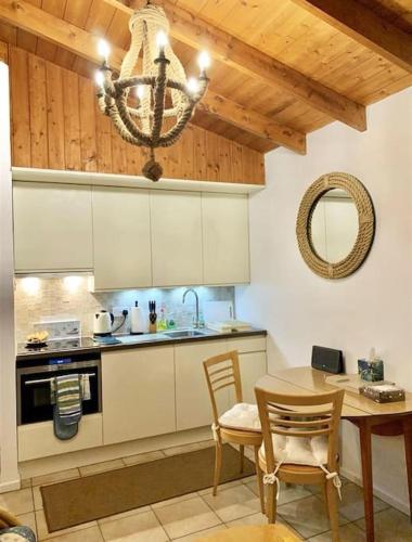 a kitchen with a table and chairs and a chandelier at Harbour Haven: Spectacular Views in Porthmadog