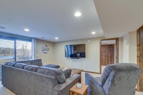 a living room with two couches and a tv at Beautiful Breezy Point Home with Beach and Dock! in Pequot Lakes