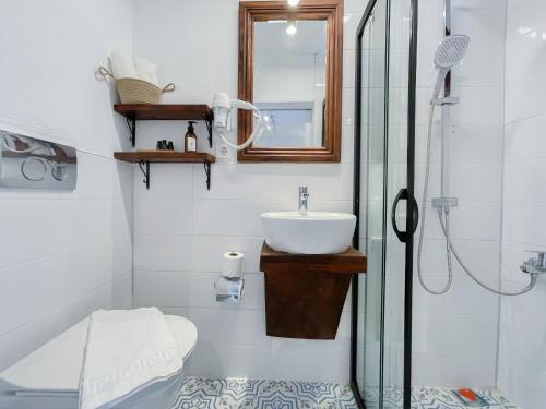 y baño con lavabo y ducha acristalada. en NİYAMA MARİNA Butik Hotel en Cesme