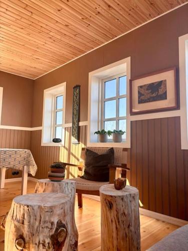 a living room with two tree stump stools in it at Jóhannshús- tradational Icelandic house in Hrepphólar