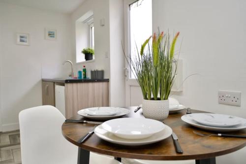 a dining room table with white plates on it at Matlock Studio 7 - Coventry in Coventry