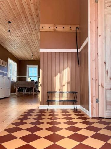 a room with a bench on a checkered floor at Jóhannshús- tradational Icelandic house in Hrepphólar