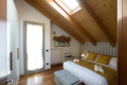 a bedroom with a large bed and a skylight at Cozy Apartment with view - LAGHI E SENTIERI - in Dolzago