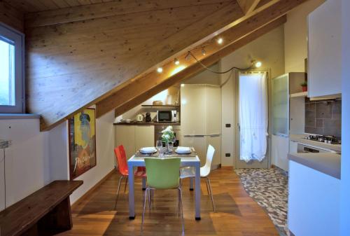 a kitchen and dining room with a table and chairs at Cozy Apartment with view - LAGHI E SENTIERI - in Dolzago
