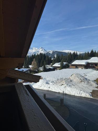 a view of a snow covered mountain from a balcony at Weinzeit Chalet in Königsleiten