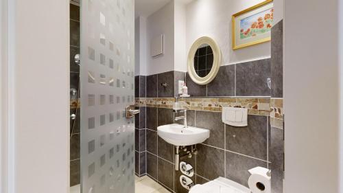 a bathroom with a sink and a toilet at Villa am Kurpark in Binz