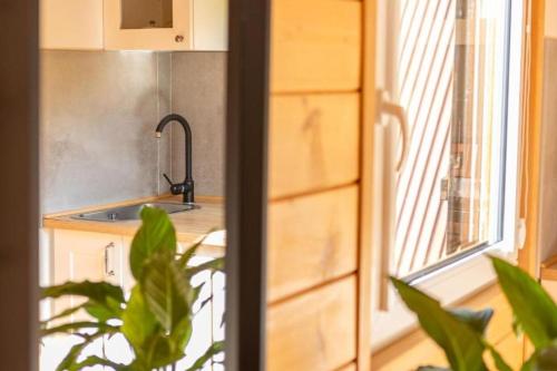 a kitchen with a sink and a window and a counter at Domek nad Zalewem Radkowskim in Wünschelburg