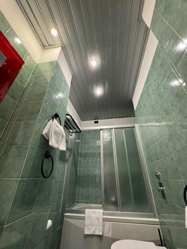 a bathroom with a shower and a toilet at Delle Nazioni Milan Hotel in Milan