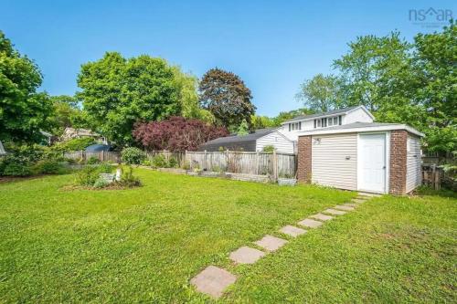 a yard with a white garage and a fence at Private Bedroom and Bathroom in Dartmouth in Halifax