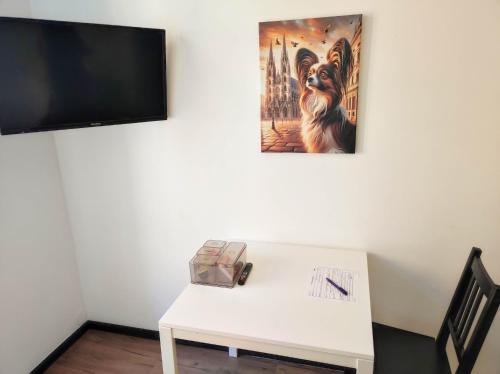 a white table with a picture of a dog on a wall at Old Vienna Apartments in Vienna