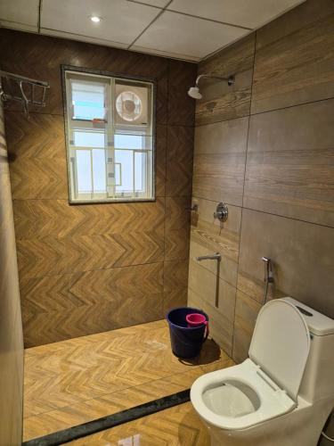 a bathroom with a toilet and a window at Swayamkrushi 2nd Floor in Hyderabad