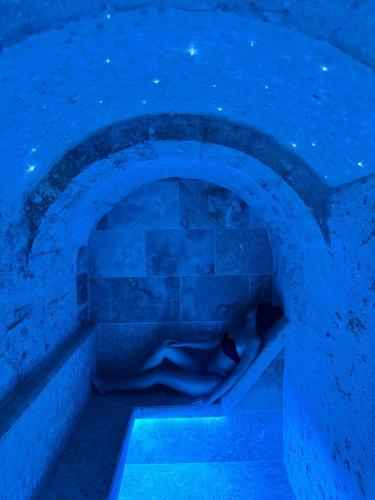 a blue lighted tunnel with a bed in it at Château de Jallanges & Spa à Vouvray - 1h de spa incluse par jour in Vouvray