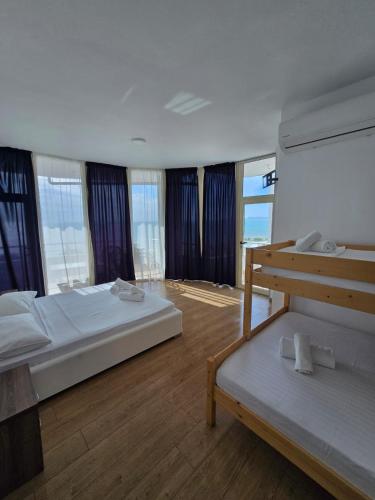 a large bedroom with two beds and windows at BLUE AMR in Durrës