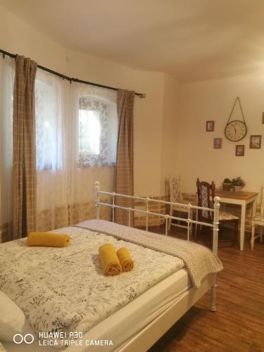 a bedroom with a bed with yellow pillows on it at Kúria Apartman Budapest with free parking in Budapest