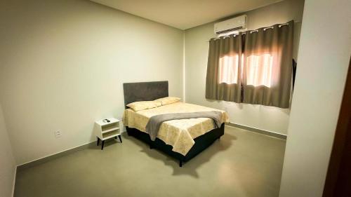 - une petite chambre avec un lit et une fenêtre dans l'établissement Chácara Recanto da Maria, à Petrolina