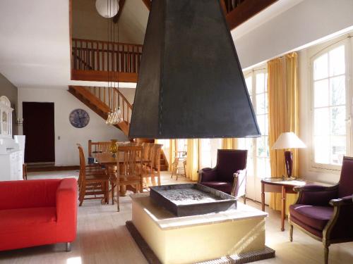 a living room with a fire place in the middle at Gîte du Grand Sancerrois in Jars
