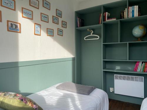 a bedroom with a bed and a book shelf at Le 7 in Mesland