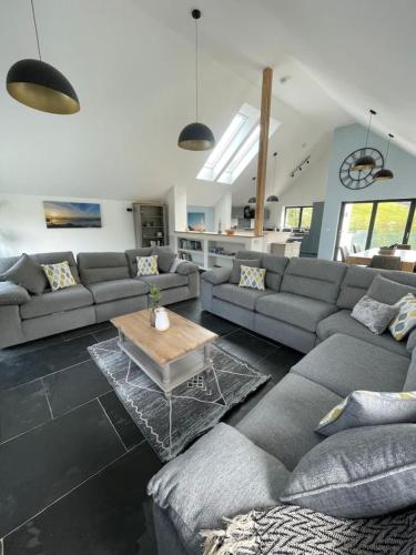 a living room with a couch and a coffee table at Gulland 4 Bed Sleeps 8 with Hot tub in Treknow