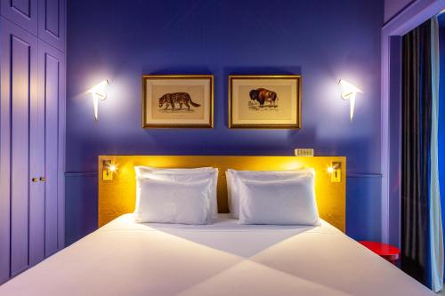 a bedroom with a white bed with two pillows at Art Legacy Hotel Baixa-Chiado in Lisbon