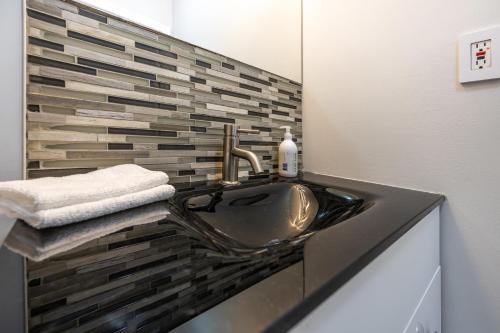 a bathroom with a sink and a mirror at Charming 1BD Getaway - Unwind Near Niagara Falls in Niagara Falls