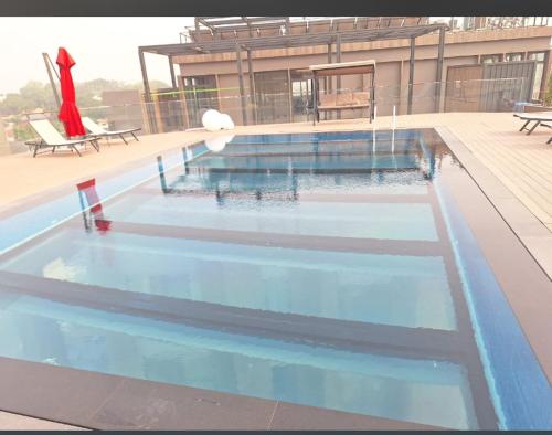 a swimming pool with blue water in front of a building at Silver bell apartments in Cantonments