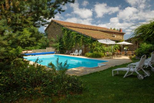 a swimming pool in the backyard of a house at Domaine de Maples in Dore-lʼÉglise