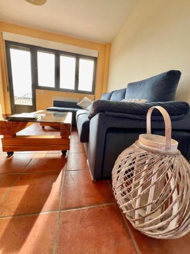 a living room with a blue couch and a table at Navalpinar in Navalmanzano