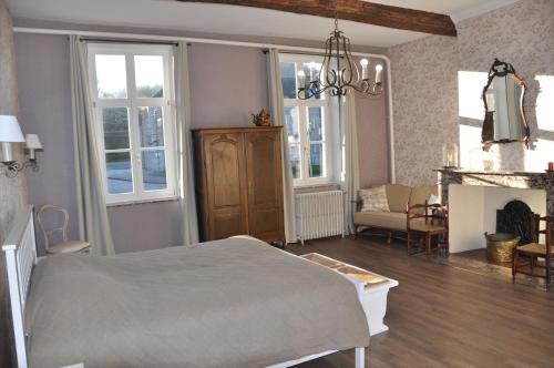 a bedroom with a bed and a living room at La Fumacienne in Fumay