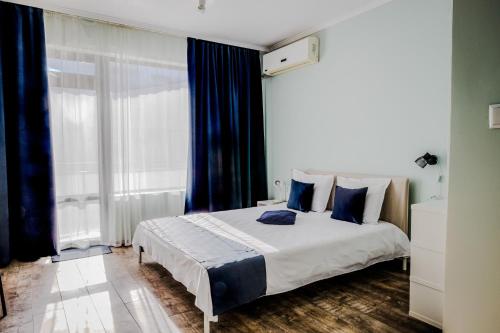 a bedroom with a large bed with blue pillows at Bo's place in St. St. Constantine and Helena