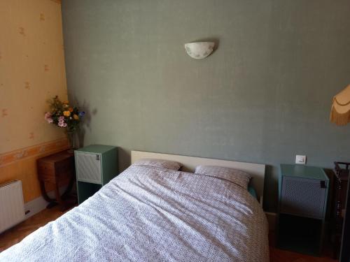 a bedroom with a bed and two night stands at La locomotive by La BB12087 in Nouvion-sur-Meuse