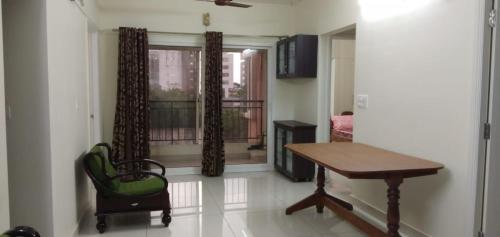 um quarto com uma secretária, uma mesa e uma janela em Bed and Brew em Chennai