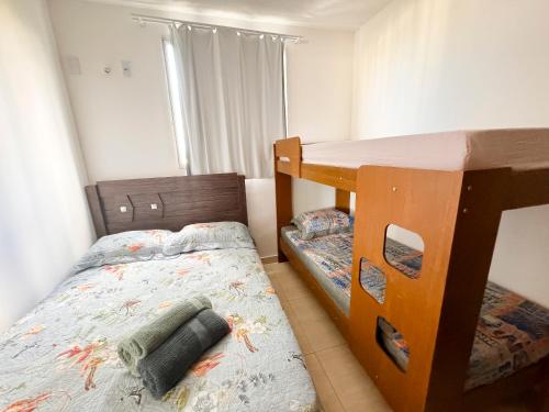 En eller flere senge i et værelse på Apartamento Aconchego beach