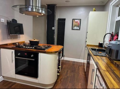 a kitchen with a stove and a counter top at Royal Troon Open Championship 24 in Prestwick