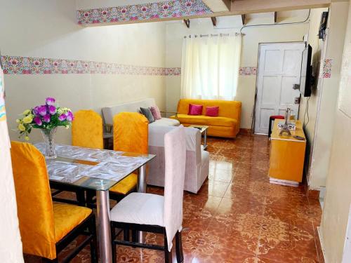 ein Wohnzimmer mit einem Tisch und gelben Stühlen in der Unterkunft Alojamiento a 6 cuadras de la plaza in Cusco