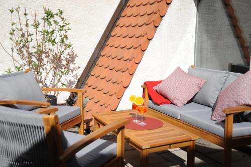 a patio with chairs and a table and a couch at Deluxe-Apartment Altstadt in Ettlingen