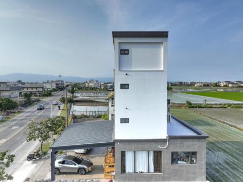a house with a tower on top of a street at Love米渡假會館 in Wujie