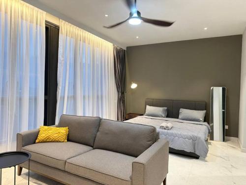 a living room with a couch and a bed at Designer Studio Sky 88 JB Town in Johor Bahru