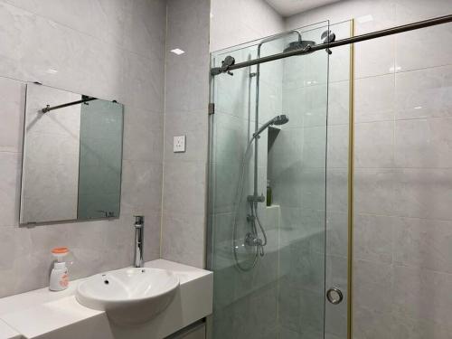 a bathroom with a glass shower and a sink at Designer Studio Sky 88 JB Town in Johor Bahru
