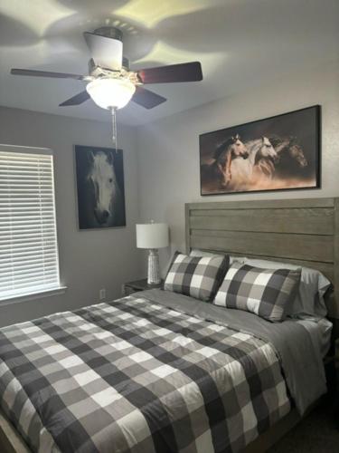 a bedroom with a bed and a ceiling fan at Serenity Cottage in Ocean Springs
