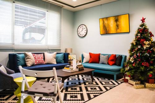 a living room with a christmas tree and a couch at Sommer 19 B&B in Luodong
