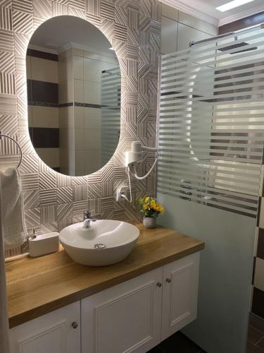 a bathroom with a sink and a mirror at Socrates Studios in Tigaki