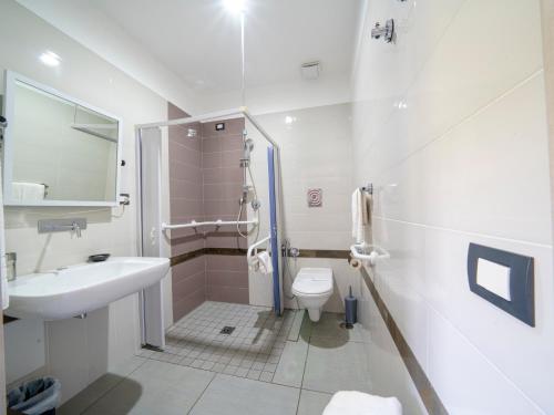 a bathroom with a sink and a toilet at Hotel Eden Park Cilento in Policastro Bussentino